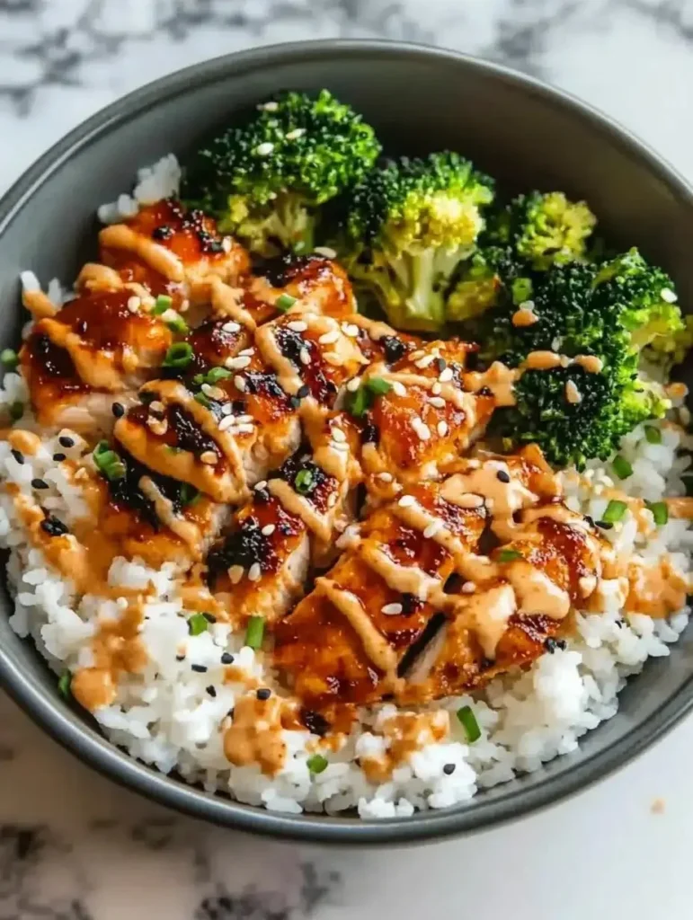 Delicious sticky chicken rice bowl with vibrant vegetables and savory sauce