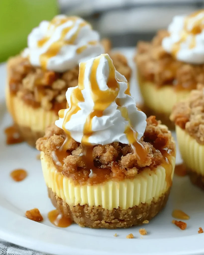 Delicious apple crisp mini cheesecakes topped with spiced apples and crumble.